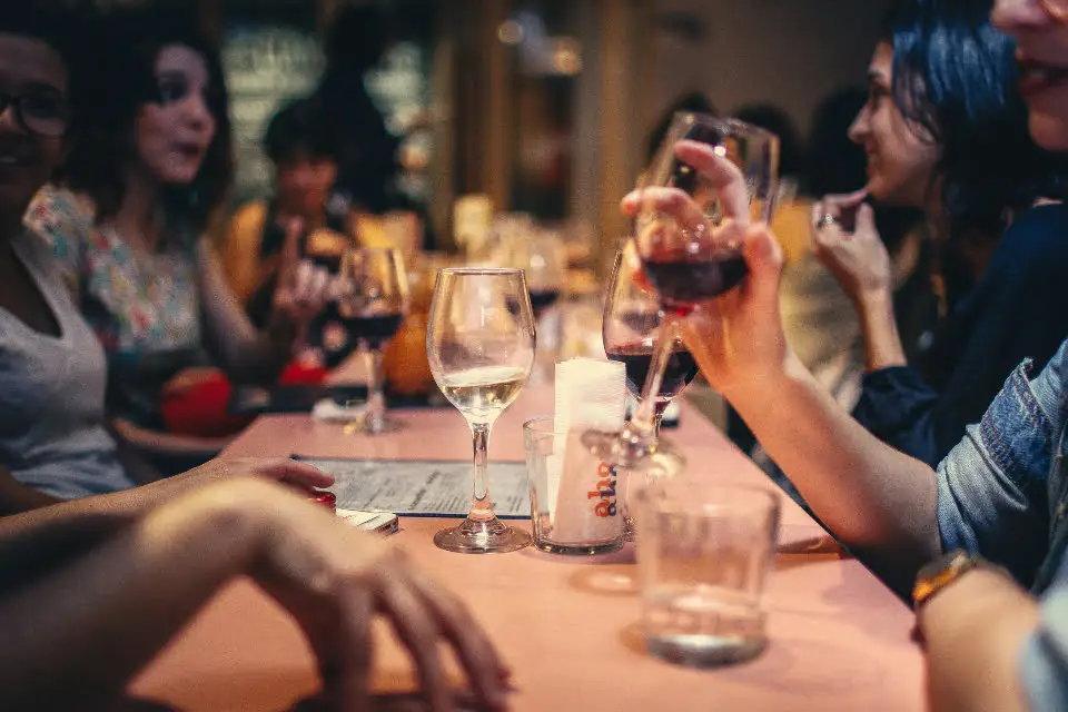 15 Compelling Reasons Why Frozen Foods Are Gaining Popularity Worldwide 7 a group of people sitting at a table with wine glasses
